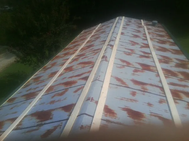 Rusted metal roof panels with new wood purlins before replacement — Storm Damage Roof Repair in Nutley by Roofing Brothers