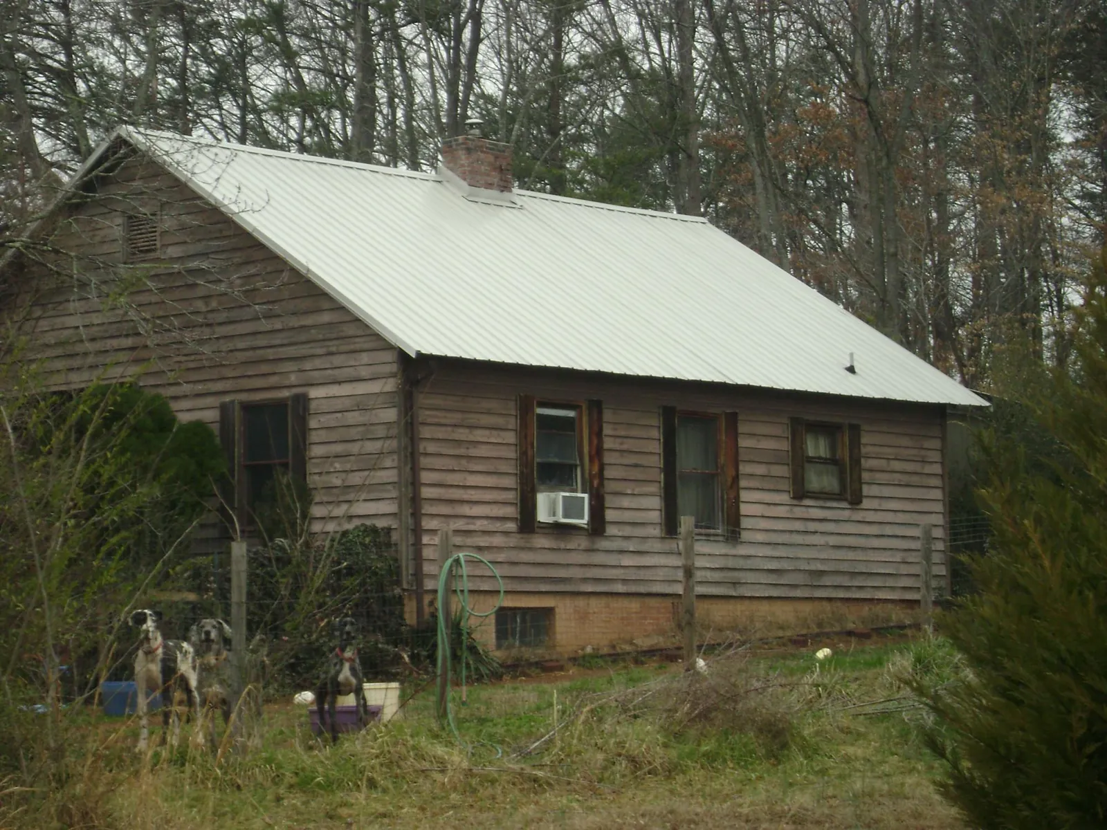 White metal roof on an old wood sided farmhouse, from a Metal Roof Installation job in Nutley